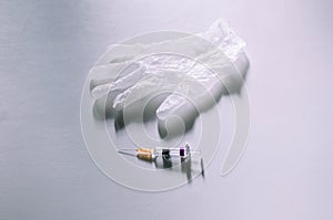 Medical syringe and gloves on a white background