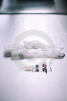 Medical syringe and gloves on a white background