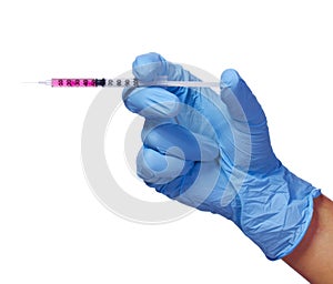 Medical syringe in hand with blue glove isolated on white. Injection