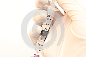 Medical - Syringe with hand and white background
