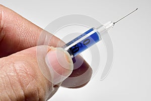 Medical syringe held with fingers