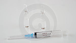 Medical syringe with the inscription coronavirus vaccine on a white background,ampoules with medicine.