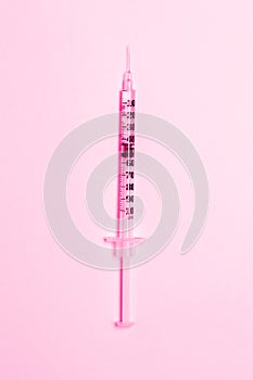 Medical syringe on a pink background. Health and vaccination concept. Cosmetology.Flat lay, copy space