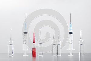 Medical syringes and ampules in a row