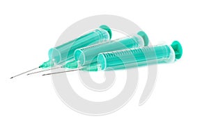 Medical syringes with needles lying isolated over white background