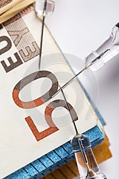Medical syringes on wad of several euro banknotes bills