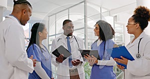 Medical, tablet and a doctor talking to nurses in the hospital for teamwork or planning treatment. Healthcare, meeting