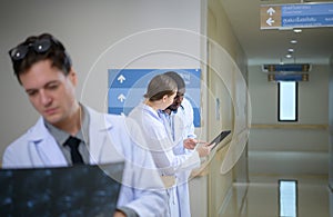 Medical teacher and interns analyzing the x-ray results of the patient\'s brain.