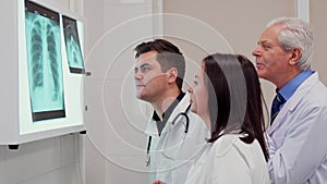 Medical team analizes x-ray on x-ray view box