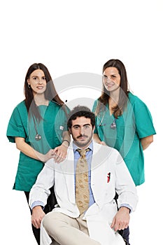 Medical team with bearded doctor and beautiful female surgeons smile. Doctors staff. Caucasian. Isolated on white. photo