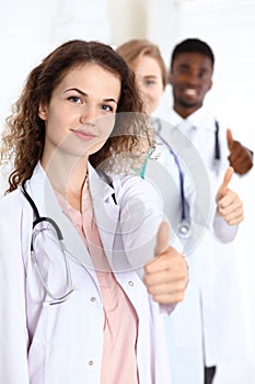 Medical team of confident doctors showing Ok sign with thumbs up. Medicine and health care, insurance concept