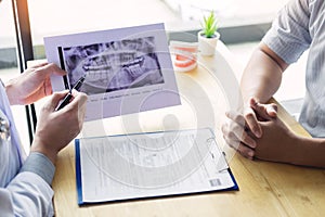 Medical team discussing, health care talking to female patient, Medical conferrence concept, doctor holding and looking at dental