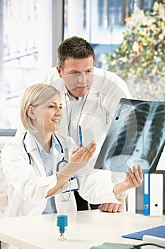 Medical team discussing x-ray image