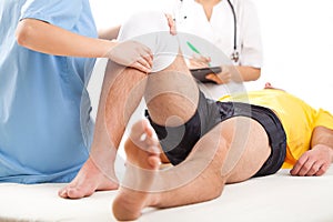 Medical team examining knee condition