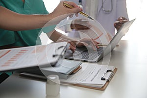 Medical Team Meeting Around Table In Modern Hospital