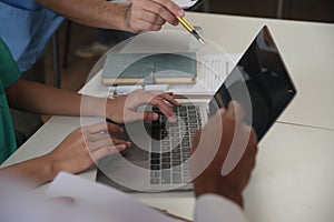 Medical Team Meeting Around Table In Modern Hospital