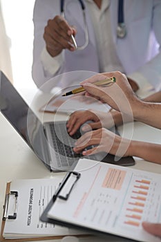 Medical Team Meeting Around Table In Modern Hospital