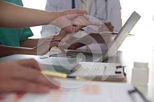 Medical Team Meeting Around Table In Modern Hospital