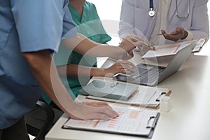 Medical Team Meeting Around Table In Modern Hospital