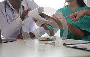 Medical Team Meeting Around Table In Modern Hospital