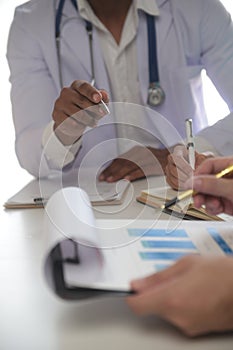 Medical Team Meeting Around Table In Modern Hospital