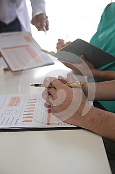 Medical Team Meeting Around Table In Modern Hospital