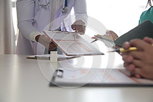 Medical Team Meeting Around Table In Modern Hospital