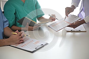 Medical Team Meeting Around Table In Modern Hospital