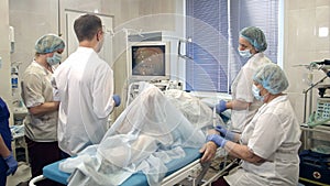 Medical team performing gastro-endoscopy to patient in hospital photo