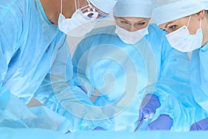 Medical team performing operation. Three of surgeons at work are busy of patient. Medicine, veterinary or healthcare and