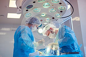 Medical Team Performing Surgical Operation in Modern Operating Room. Rhinoplasty