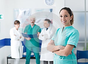 Medical team posing at the hospital and young nurse