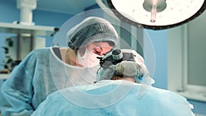 A medical team of surgical specialists working in the modern operating room of the hospital, performing team preparation