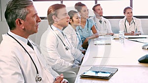 Medical team talking together while applauding