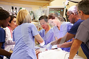 Medical Team Working On Patient In Emergency Room photo