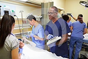 Medical Team Working On Patient In Emergency Room photo