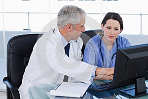 Medical team working together with a computer