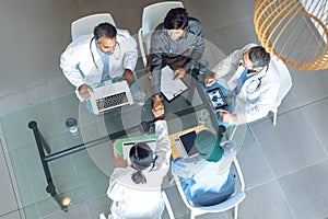 Medical team working together at table in hospital