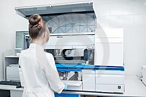 Medical technician working with analyzer