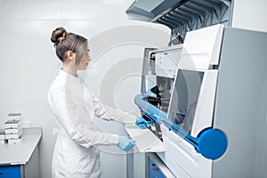 Medical technician working with analyzer
