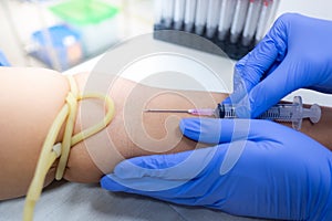 Medical technologist doing a blood draw services for patient.