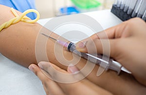 Medical technologist doing a blood draw services for patient.