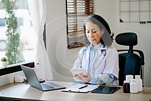 Medical technology concept. Doctor working with mobile phone and stethoscope in modern office