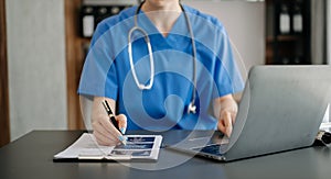 Medical technology concept. Doctor working with mobile phone and stethoscope in modern office