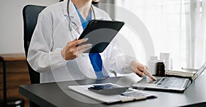 Medical technology concept. Doctor working with mobile phone and stethoscope in modern office