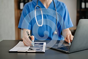 Medical technology concept. Doctor working with mobile phone and stethoscope in modern office