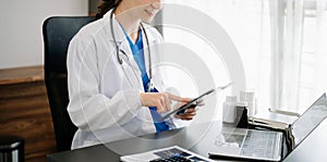 Medical technology concept. Doctor working with mobile phone and stethoscope in office