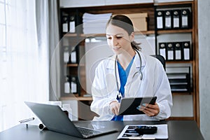 Medical technology concept. Doctor working with mobile phone and stethoscope in office