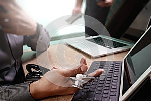 Medical technology network team meeting concept. Doctor hand working smart phone keyboard docking digital tablet screen laptop co