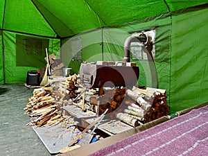 Medical tent on the battlefield Places to warm up Rest point and steadfastness Wartime Firewood stands near the stove a